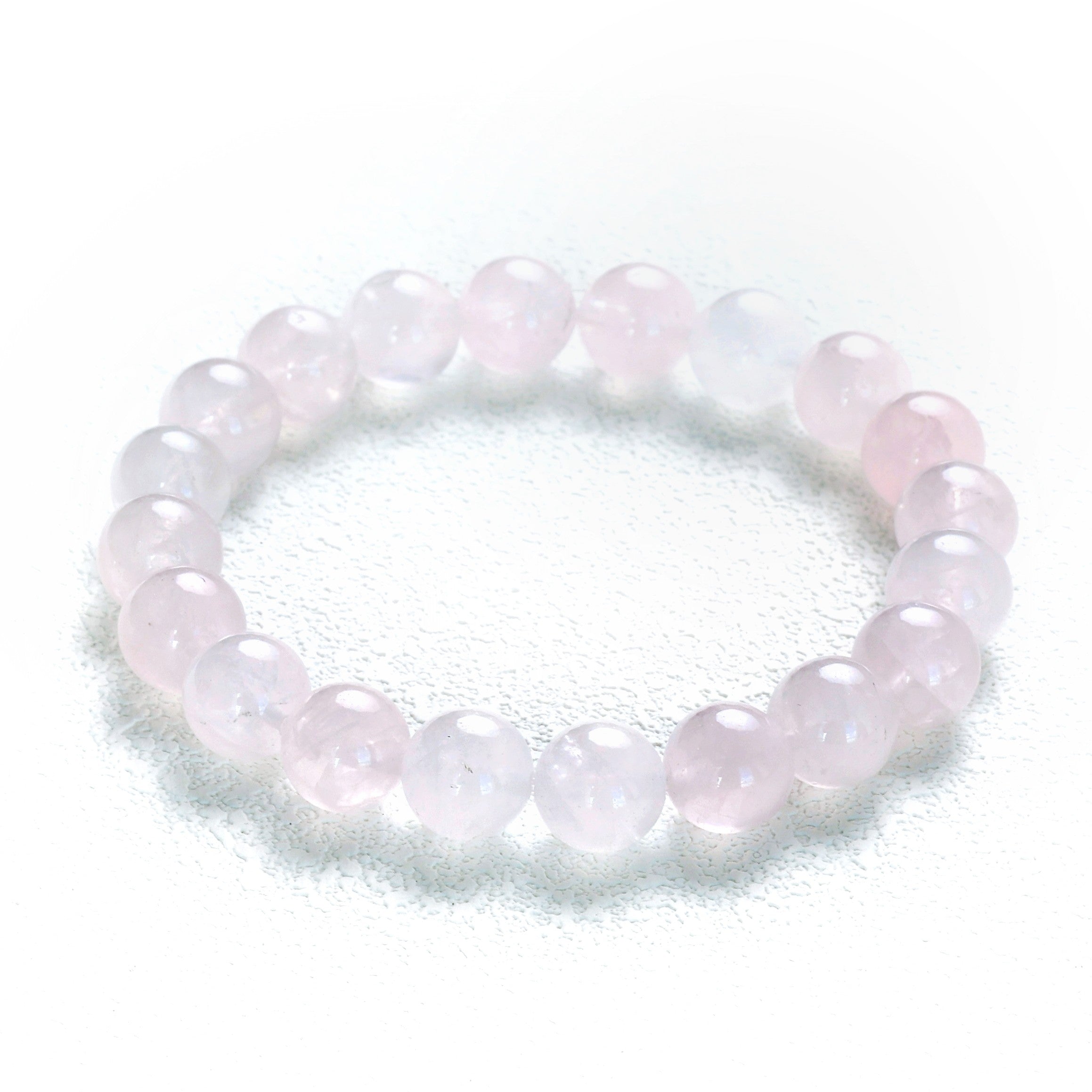 Detailed perspective of the Liminéra Glow bracelet, highlighting the comforting energy and softly diffused light within the pink crystal beads.
