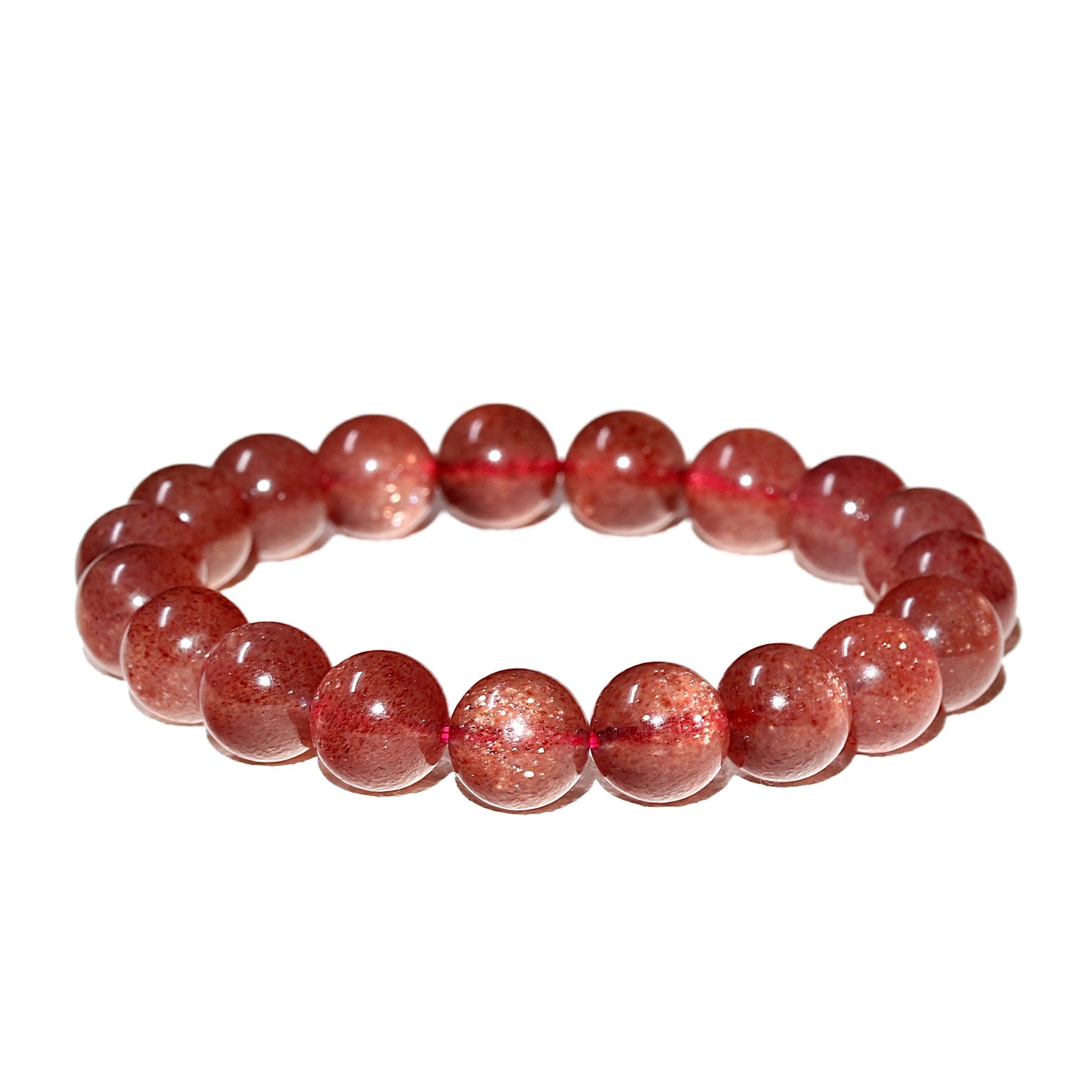 Detailed view of the Liminéra Strawberry Quartz bracelet, showcasing the suspended sparkling mineral flecks and its awakening energy.